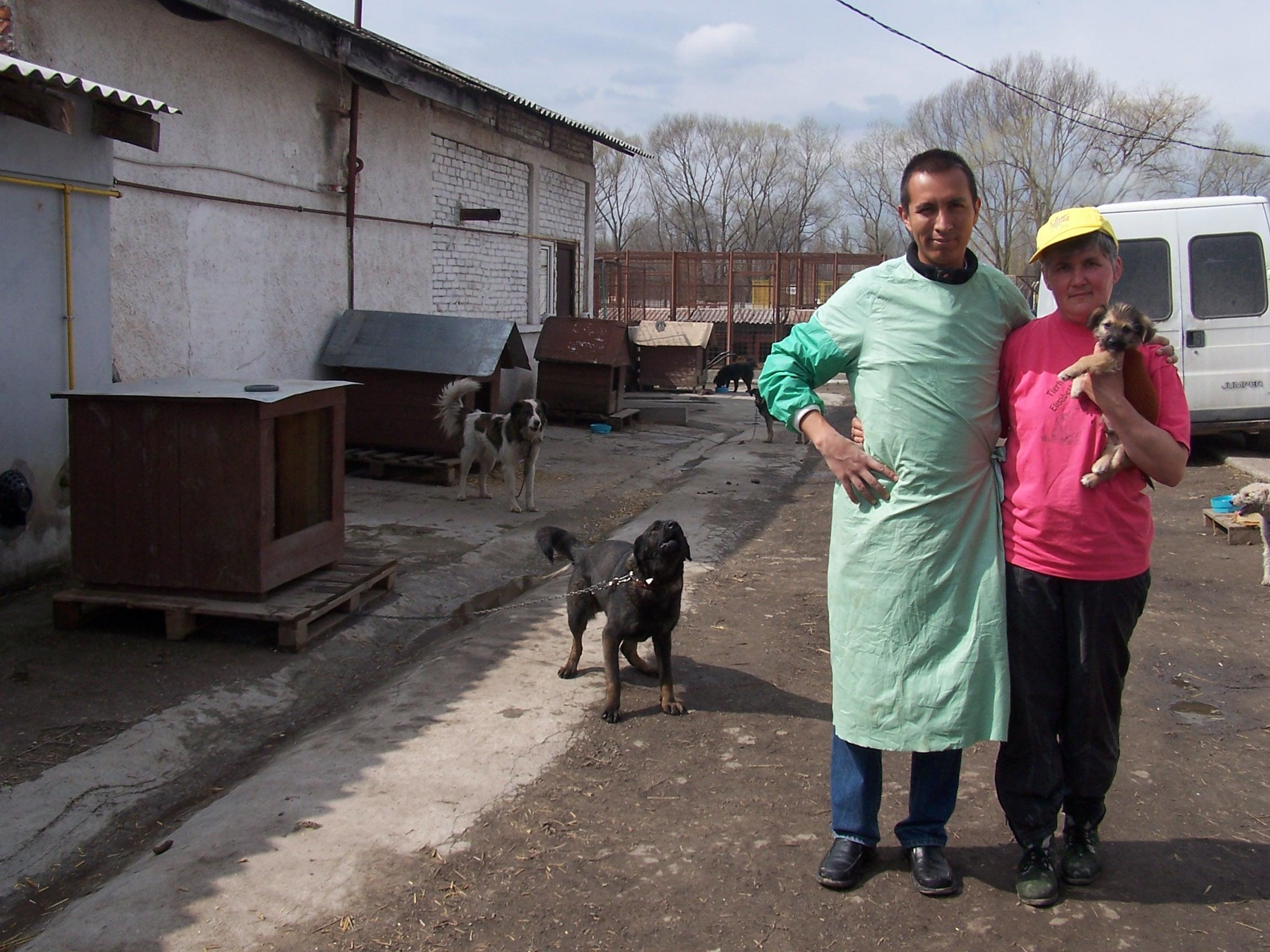 Projects Abroad volunteer stands outside with his supervisor during his Veterinary Medicine internship in Romania. Volunteer and staff member stand outside the Veterinary Medicine placement in Romania.